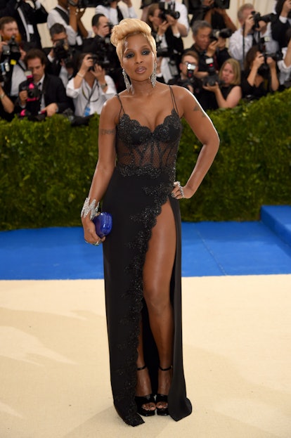 Mary J. Blige at the Met Gala in a lace gown with a high slit.