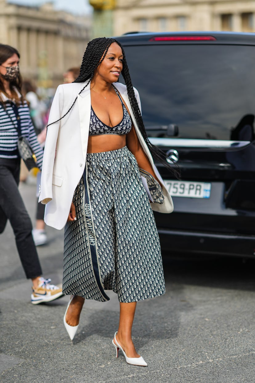 Shiona Turini in a Dior logo bra and skirt with a blazer on top during Paris Fashion Week in 2021. 
