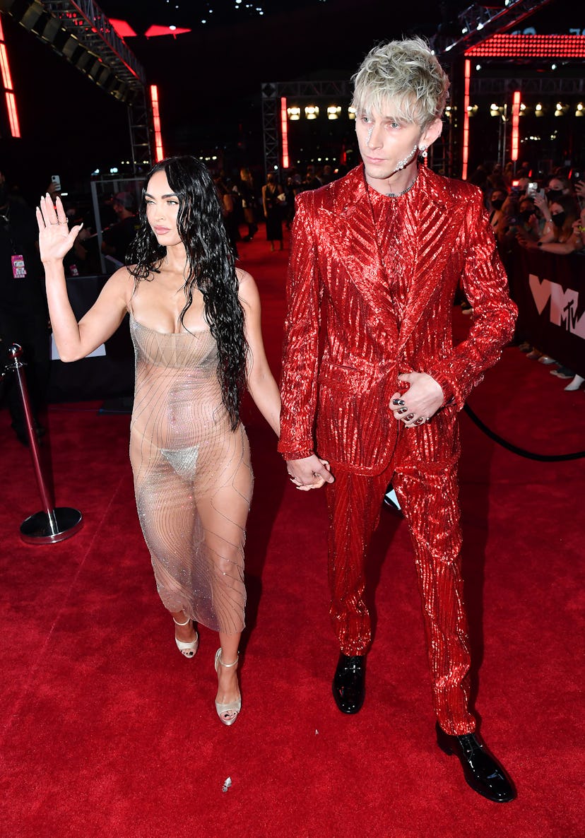 Megan Fox in a sheer gown and Machine Gun Kelly in a red, sparkly suit.