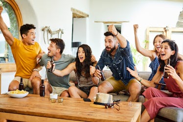 Excited young fans celebrating while watching football, for which they'll need Superbowl puns.