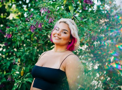 Young woman smiling in the breeze, knowing her lucky zodiac sign will have the best week of February...