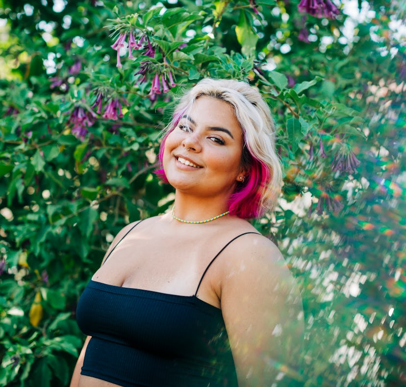 Young woman smiling in the breeze, knowing her lucky zodiac sign will have the best week of February...