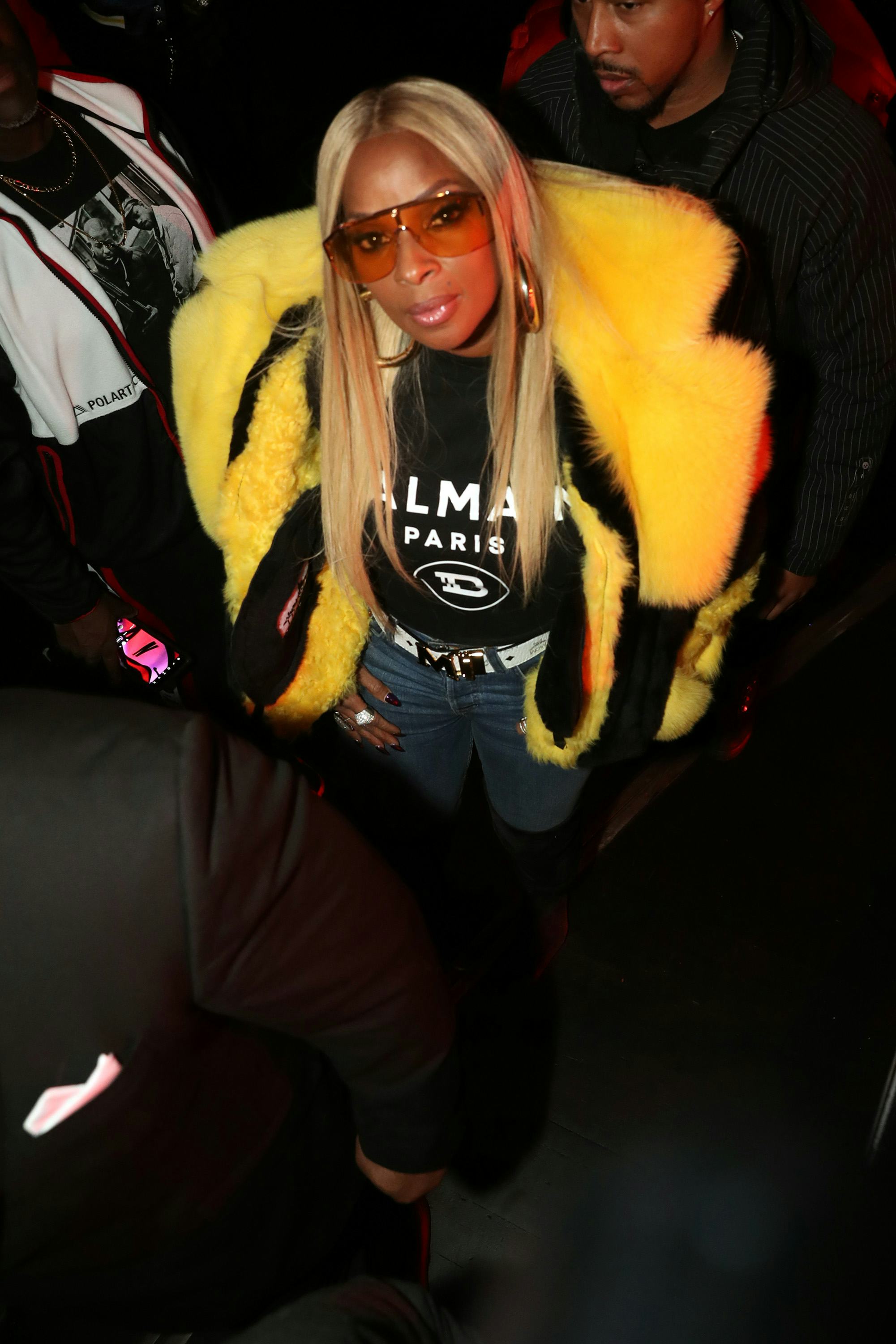 Mary J. Blige in a yellow fur coat with a Balmain shirt underneath.