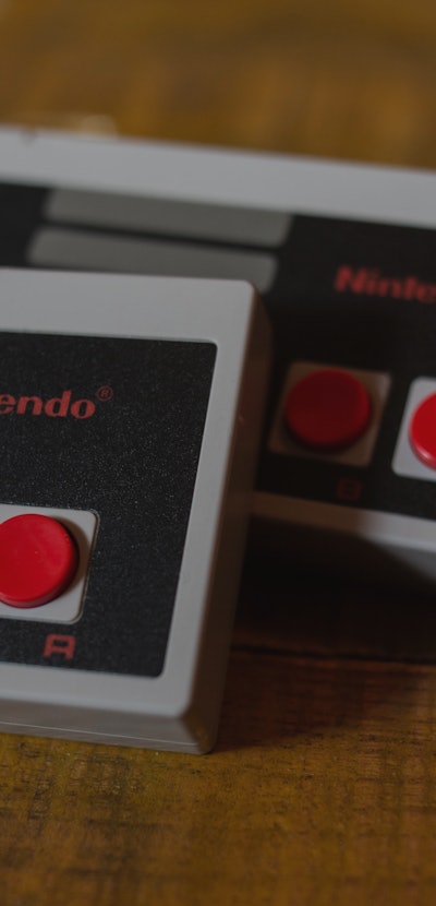 Two NES (Nintendo Entertainment System) Classic Mini controllers. 