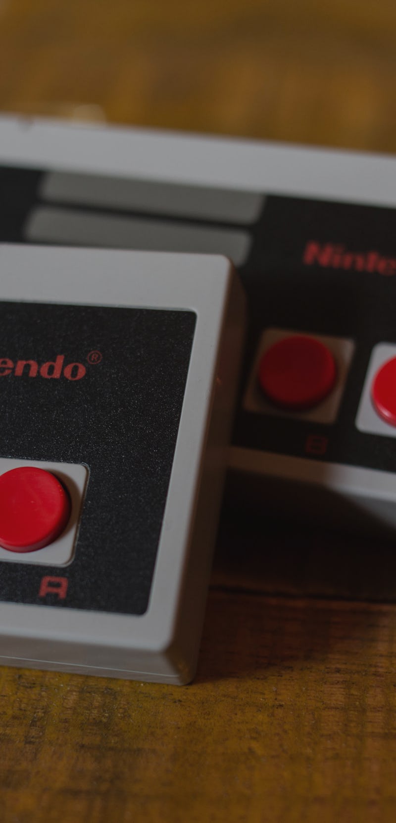 Two NES (Nintendo Entertainment System) Classic Mini controllers. 