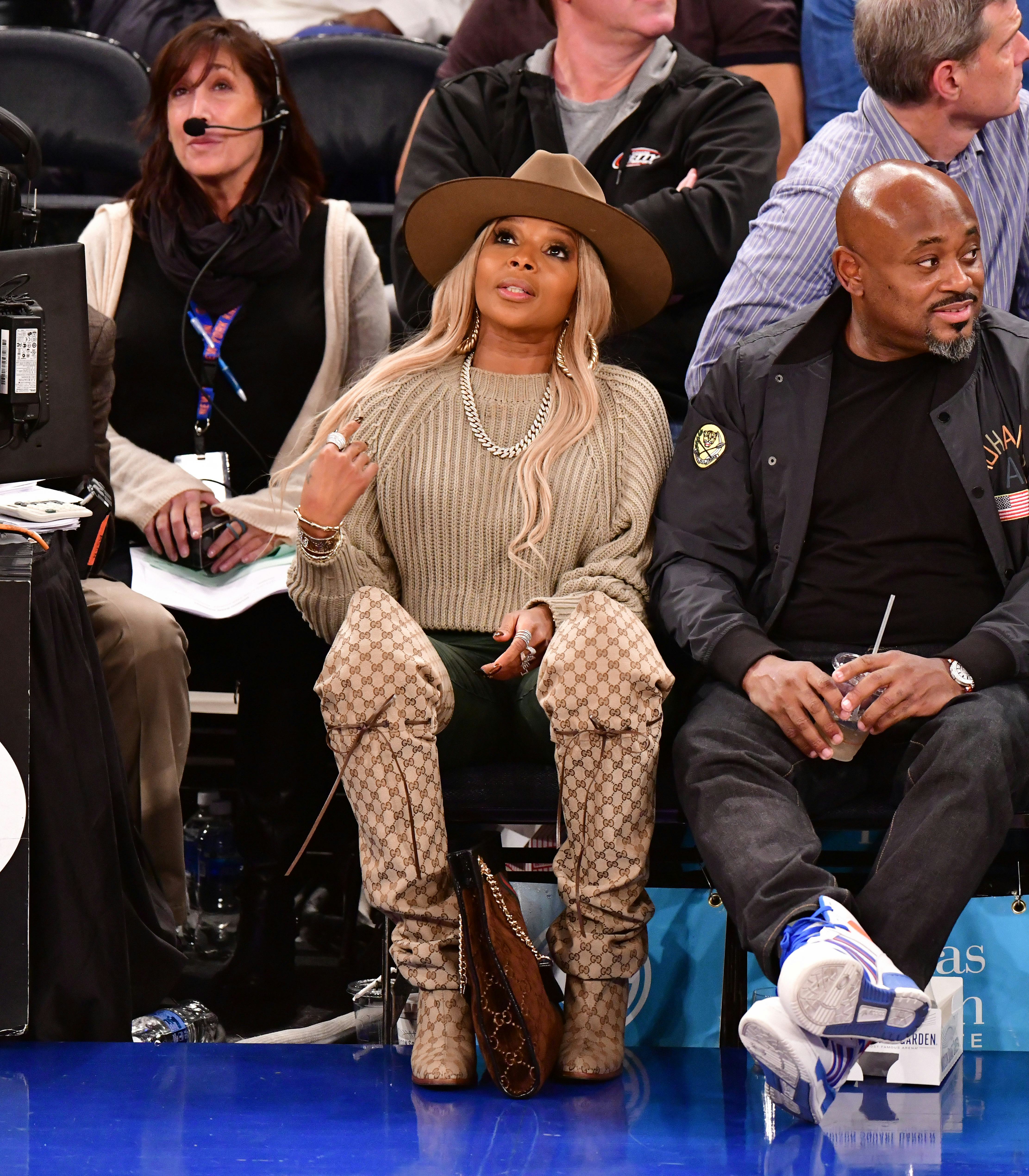 Mary J. Blige in a tan sweater and thigh high Gucci Boots.