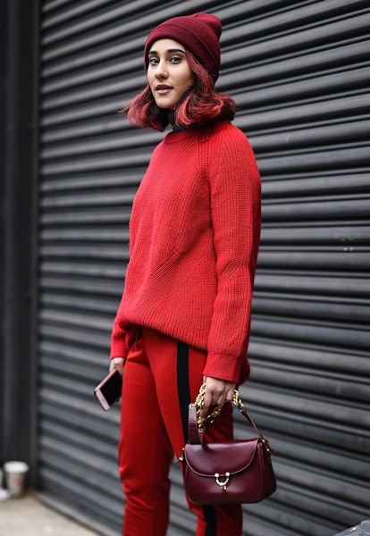 A guest wore a monochromatic, red outfit including a beanie on February 1, 2017 in New York City.