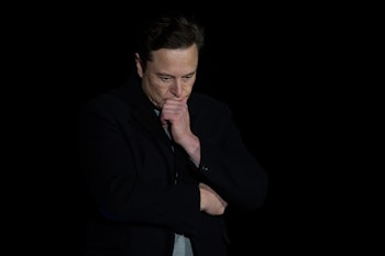 Elon Musk pauses and looks down as he speaks during a press conference at SpaceX's Starbase facility...