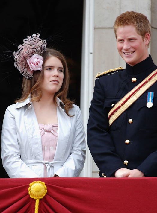 Cousins Princess Eugenie and Prince Harry standing on a balcony. 