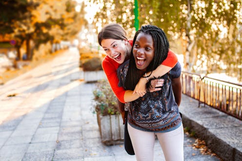 Two female friends having fun in the city park