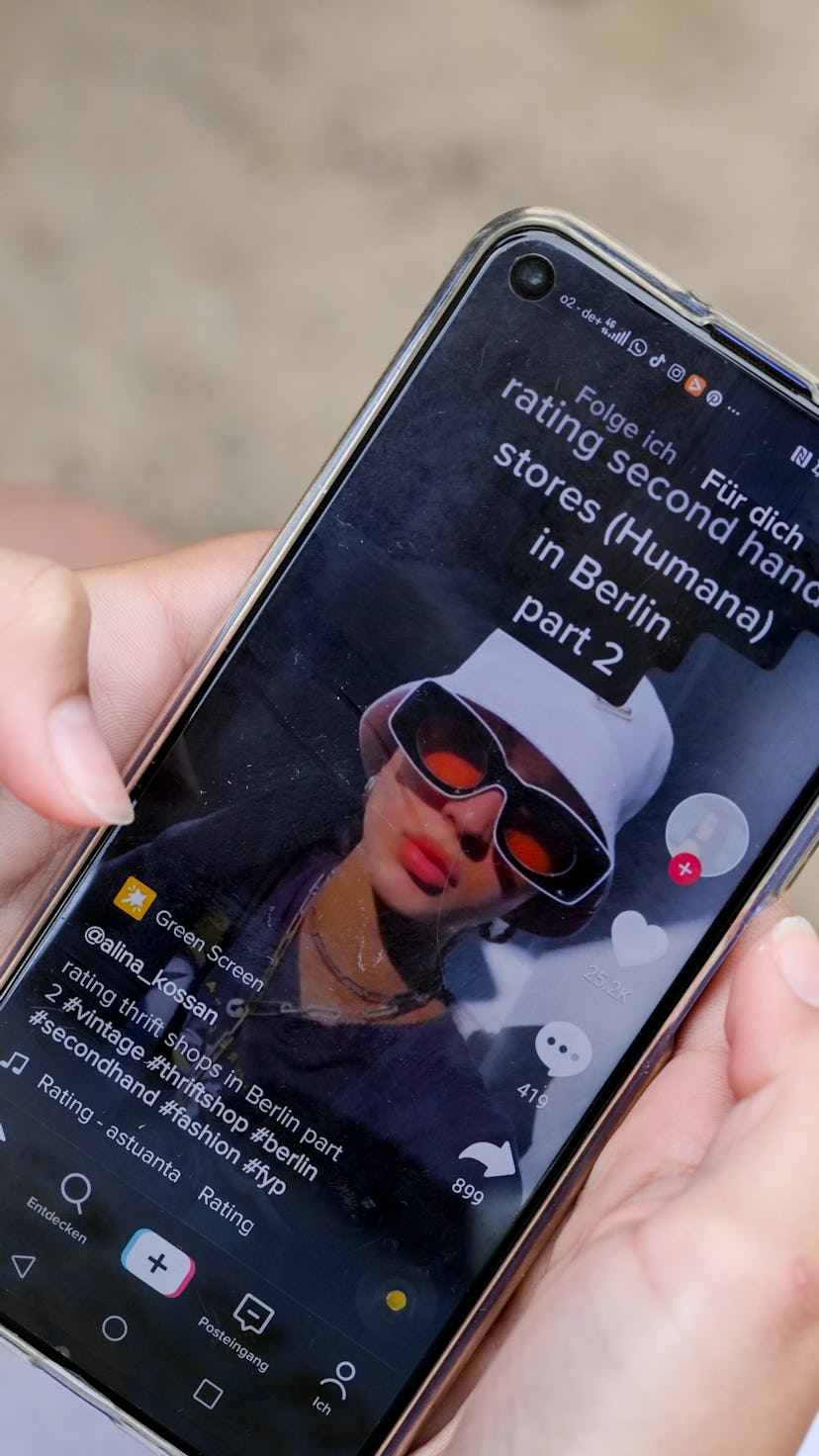 A person watches a TikTok video, where content is now being more closely regulated.