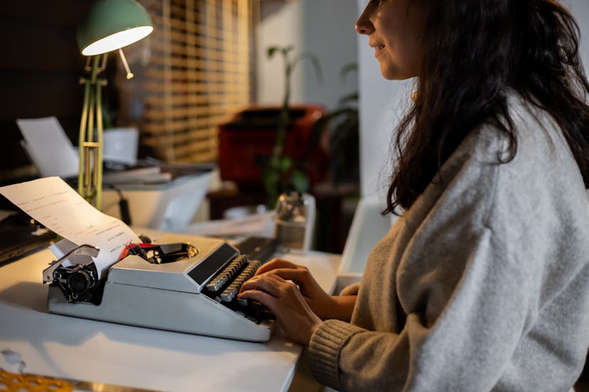Woman using typewriter at home