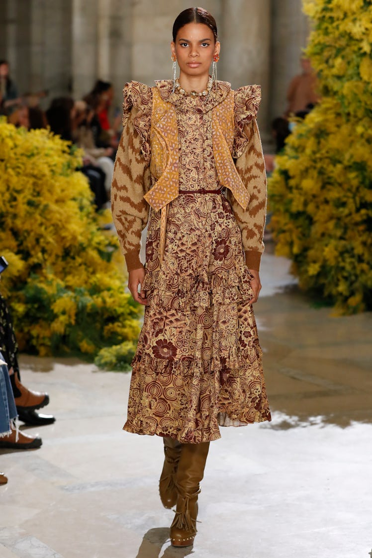 Model on the NY Fashion Week Fall 2022 runway in Ulla Johnson yellow and brown dress with flower det...