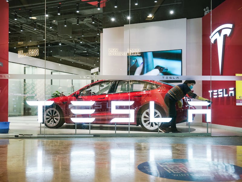 BEIJING, CHINA - FEBRUARY 14: A worker cleans a Tesla signage at a Tesla showroom on February 14, 20...
