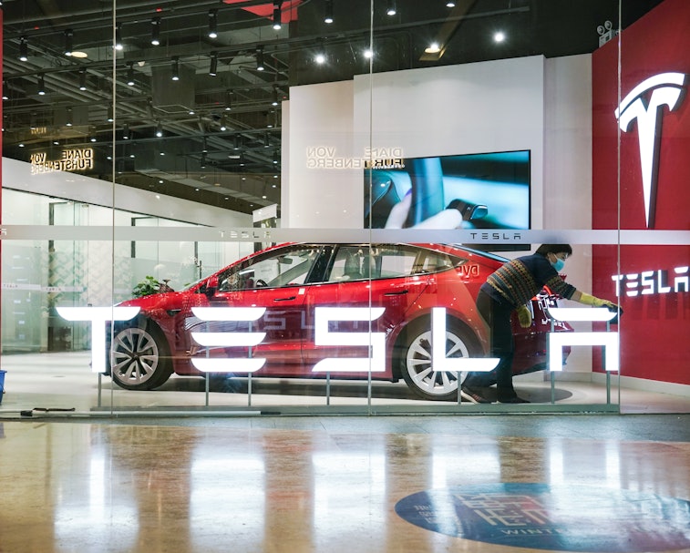 BEIJING, CHINA - FEBRUARY 14: A worker cleans a Tesla signage at a Tesla showroom on February 14, 20...