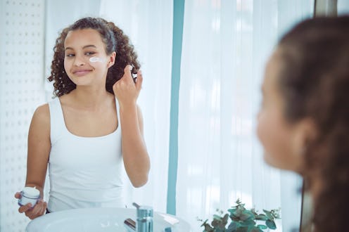 Beautiful mixed race teenager getting ready in the bathroom