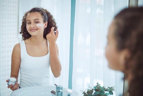 Beautiful mixed race teenager getting ready in the bathroom