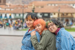 Positive young women friends in casual clothes hugging. Here's what it means if you're a life path n...