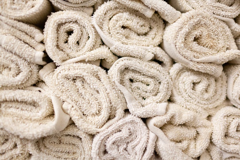 Rolled bath towels stacked together