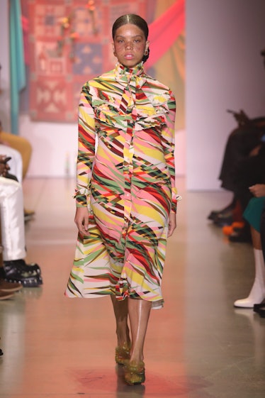 Model on the NY Fashion Week Fall 2022 runway in House of Aama colorful turtleneck dress.
