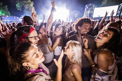 Large group of cheerful people having fun on a music concert. Here's how to find live events on Snap...