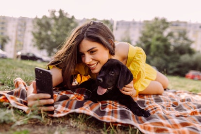 Female pet owner taking a selfie with her Labrador