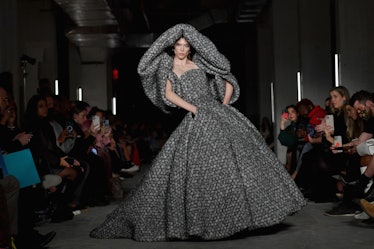 Model on the NY Fashion Week Fall 2022 runway in Christian Siriano grey dress with puffy sleeves and...