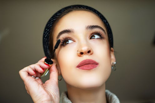 Beautiful woman with beauty face, makeup and long black eyelashes