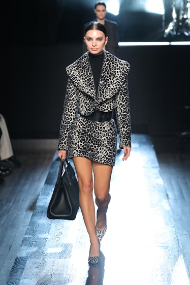 A model walking on the NY Fashion Week Fall 2022 runway in Michael Kors cheetah print heels, skirt a...