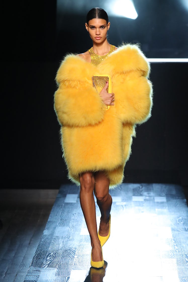 Model on the NY Fashion Week Fall 2022 runway in a Michael Kors yellow fur coat