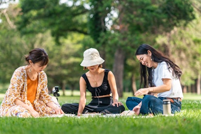 a group of women enjoy their picnic as they discuss 2022 spring equinox