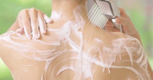 closeup of beauty girl back is taking shower