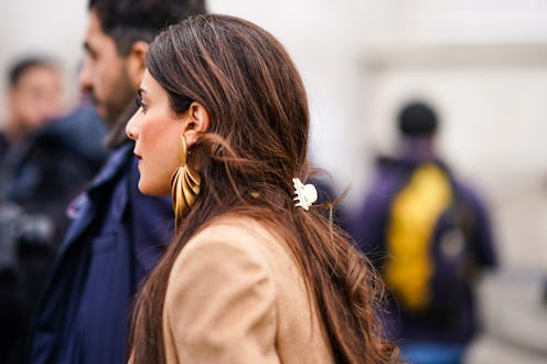 PARIS, FRANCE - FEBRUARY 29: A guest wears golden earrings, outside Elie Saab, during Paris Fashion ...