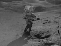 Mission Commander David R. Scott uses a 70mm camera on the Hadley Delta during the Apollo 15 lunar l...