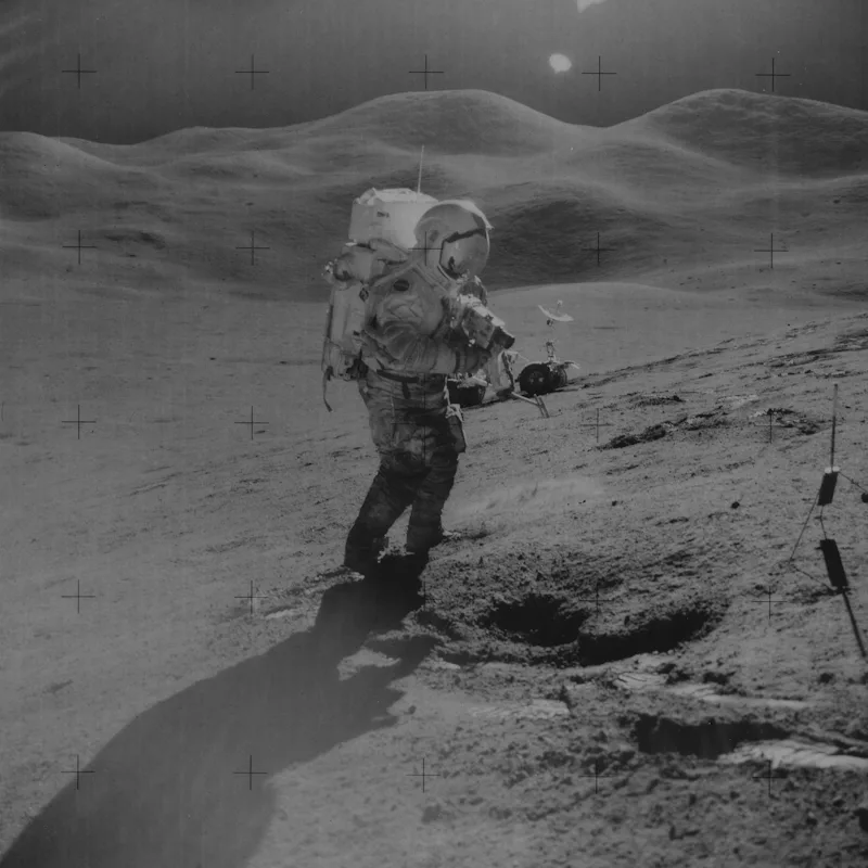 Mission Commander David R. Scott uses a 70mm camera on the Hadley Delta during the Apollo 15 lunar l...