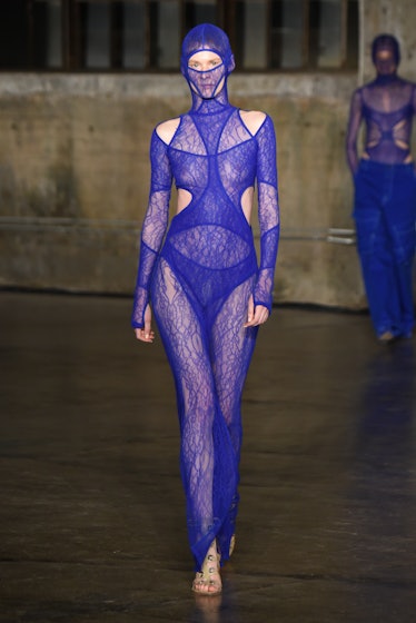 Model on the NY Fashion Week Fall 2022 runway in a Dion Lee blue see-through dress