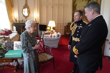 WINDSOR, ENGLAND - FEBRUARY 16: Queen Elizabeth II speaks with Rear Admiral James Macleod and Major ...