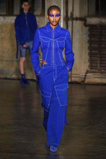 Model on the NY Fashion Week Fall 2022 runway in a Dion Lee blue denim jacket and blue denim pants