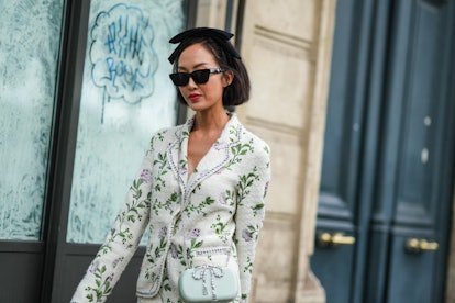 PARIS, FRANCE - OCTOBER 04: Chriselle Lim wears sunglasses, a black knotted headband, a white tweed ...