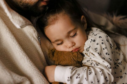 Could this young girl asleep on her father's lap have taken melatonin to go down easily? 
