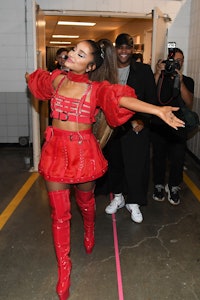 Ariana Grande in a matching harness and red mini skirt during her Sweetener World Tour on March 18, ...