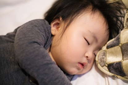 Could this peacefully sleeping Asian baby been given melatonin as a sleep aid? 