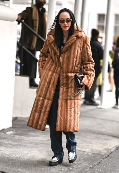 NEW YORK, NEW YORK - FEBRUARY 16: A guest is seen wearing a brown puff coat outside the Collina Stra...