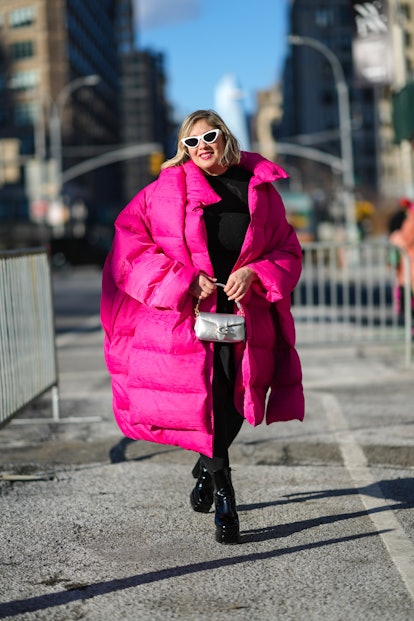 NEW YORK, NEW YORK - FEBRUARY 14: A guest wears a white vintage sunglasses, a black knees dress, bla...