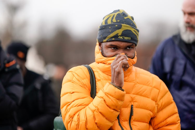 PARIS, FRANCE - JANUARY 17: Frank Ocean wears an orange puffer jacket, a beanie hat from Arc'Teryx, ...