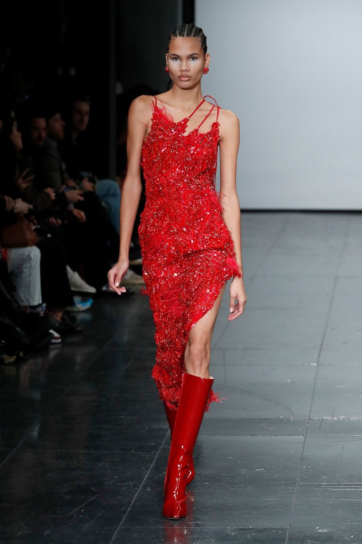 A model in a red asymmetric sequin dress by Conner Ives