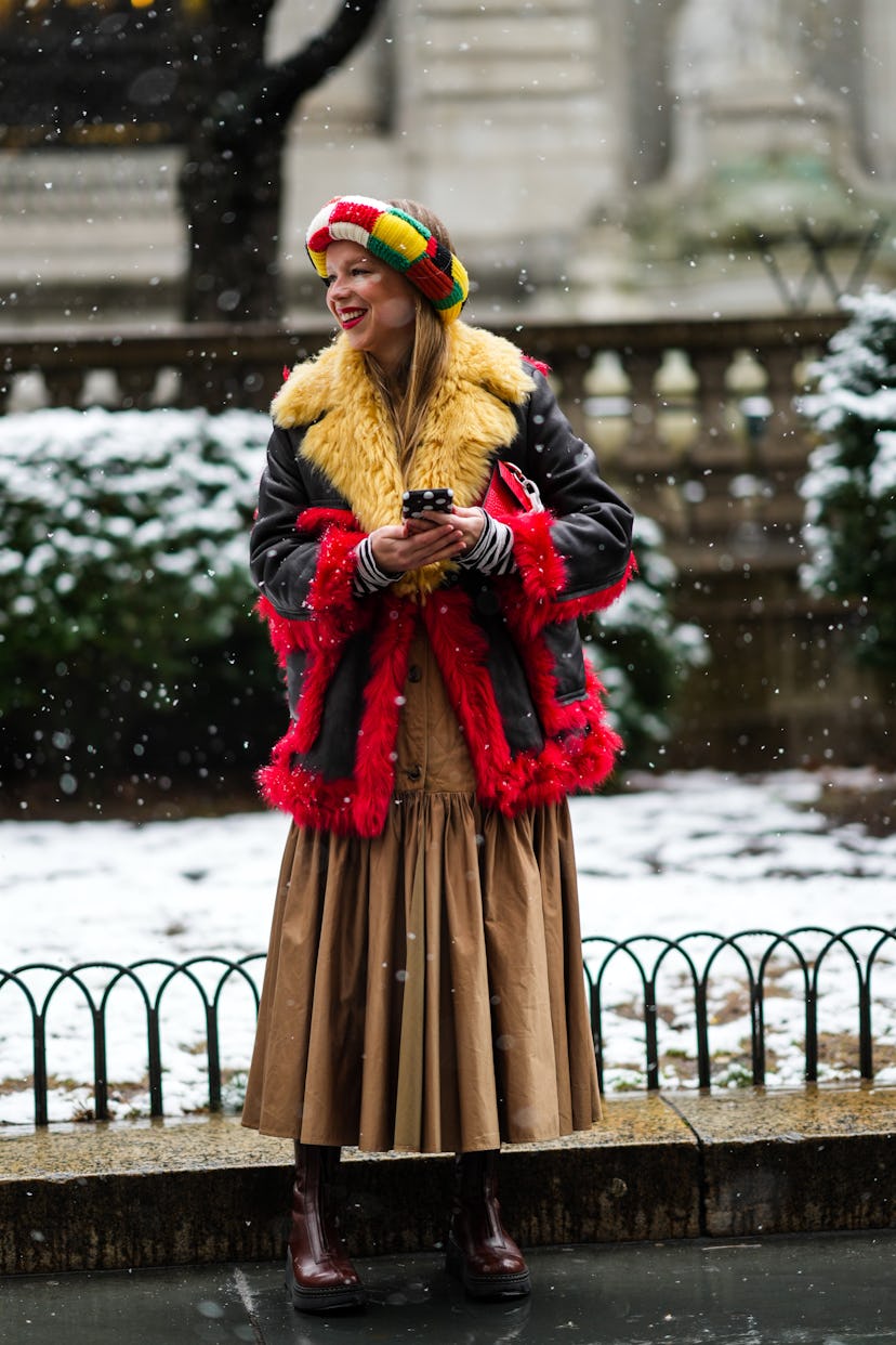 NEW YORK, NEW YORK - FEBRUARY 13: A guest wears a black / white / red / yellow / green checkered pri...