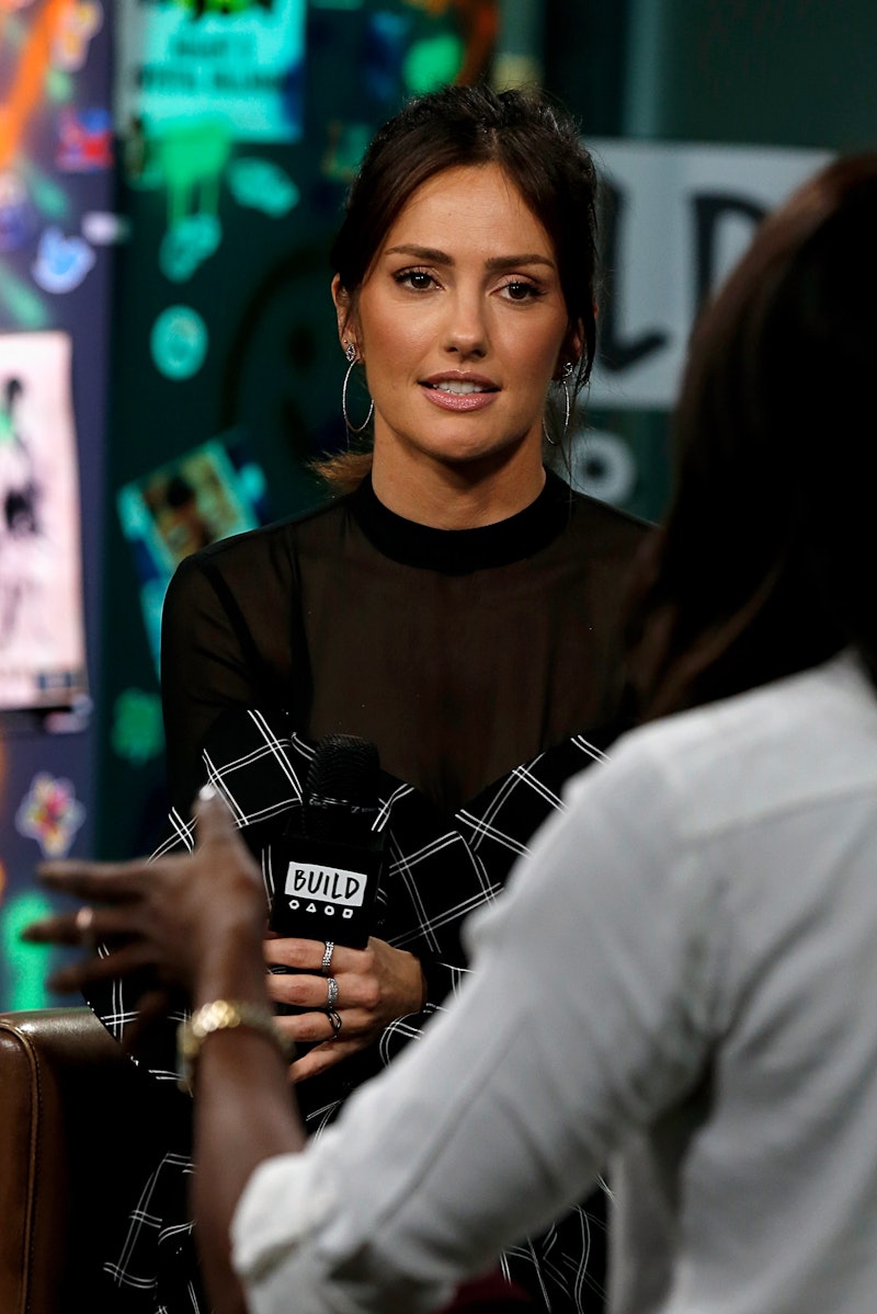 Minka Kelly holding a microphone and speaking to someone out of frame. (Photo by Dominik Bindl/Getty...