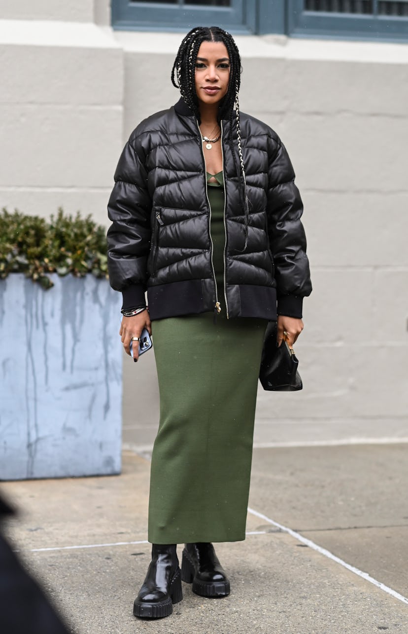 NEW YORK, NEW YORK - FEBRUARY 13: Hannah Bronfman is seen wearing a black puff coat and green dress ...