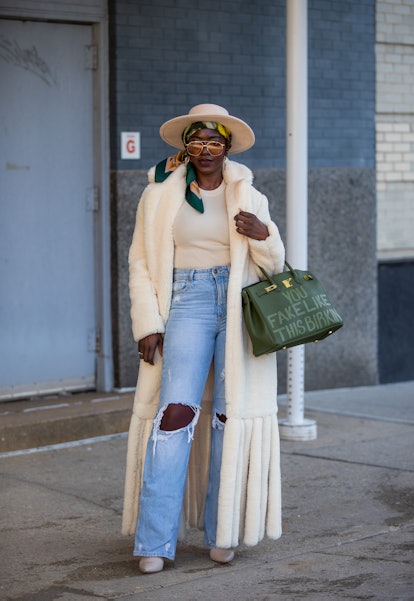 NEW YORK, NEW YORK - FEBRUARY 15: A guest is seen wearing green fake birkin Hermes bag during New Yo...